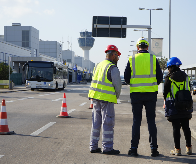 Three engineers with helmets on the the road supervise the project