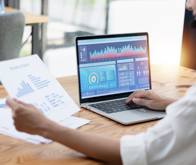 Employee working in laptop with financial documents