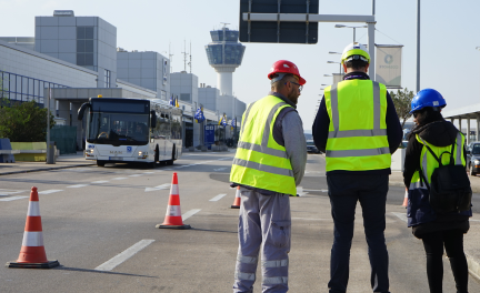 Three engineers with helmets on the the road supervise the project