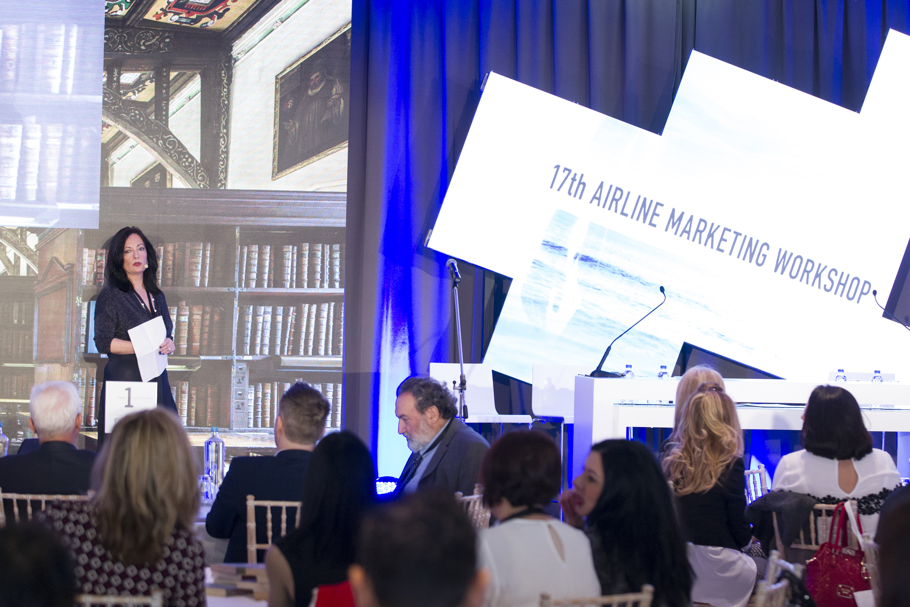 Woman speaker giving presentation to group of people