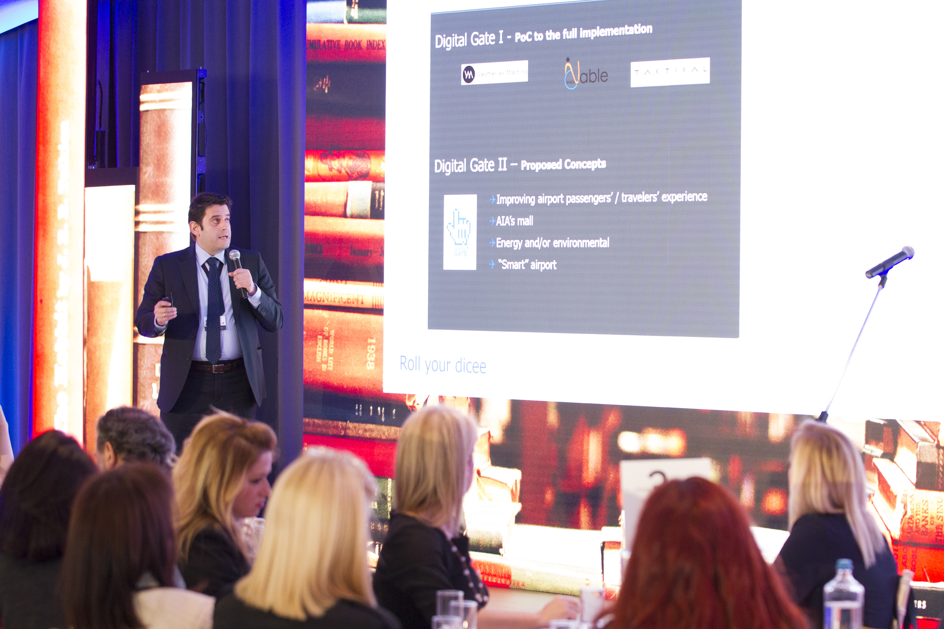Male speaker giving presentation to group of people