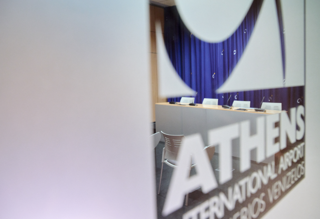 Glass door with the Athens International Airport logo