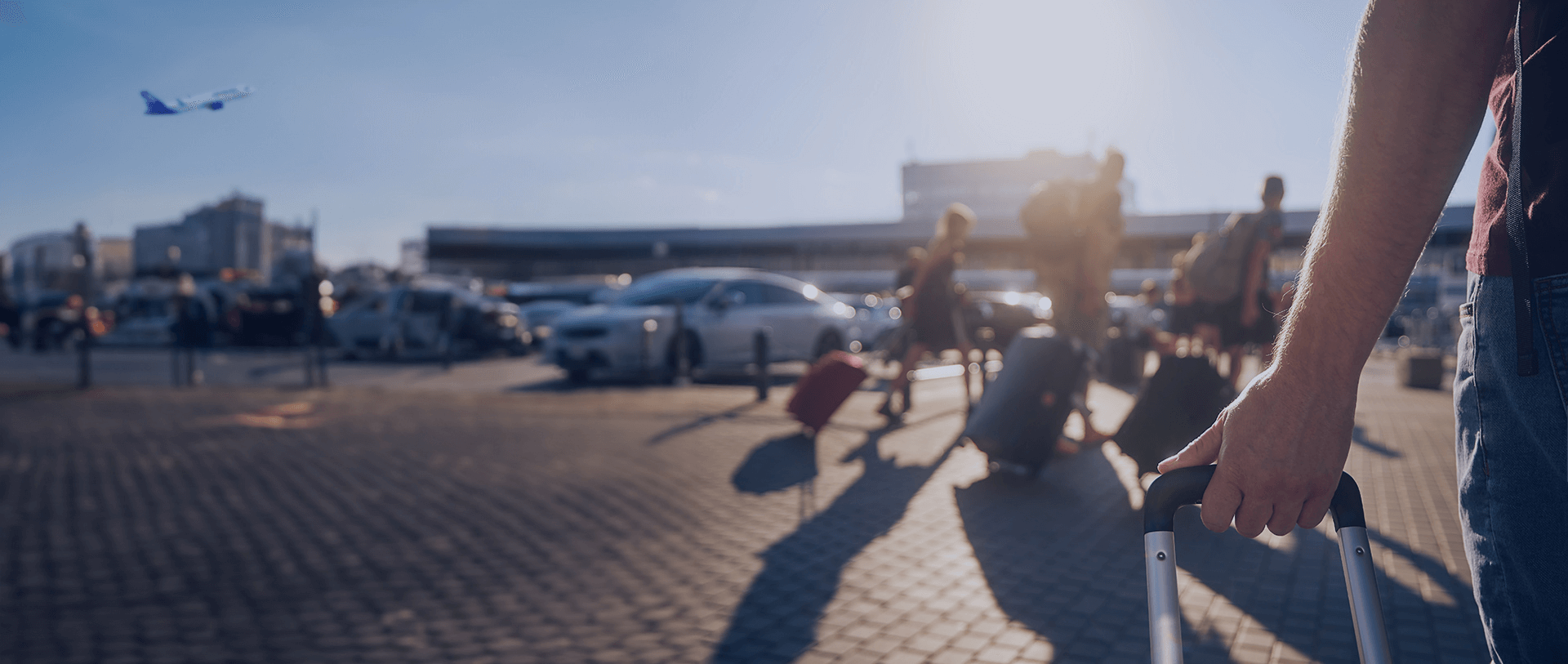 People with luggage outside of Athens International Airport