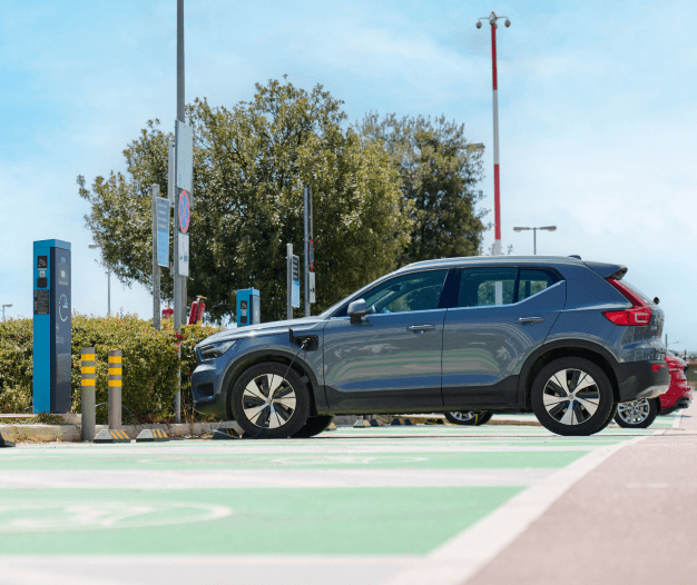 electric cars in front of a charger athens international airport