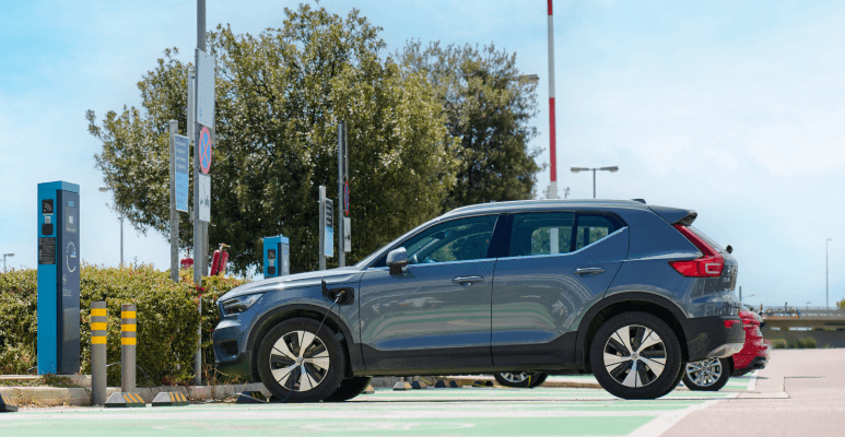 electric cars in front of a charger athens international airport