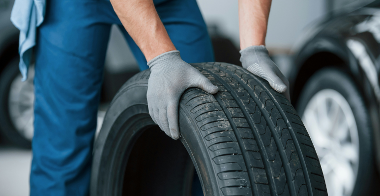 person rolling a tire