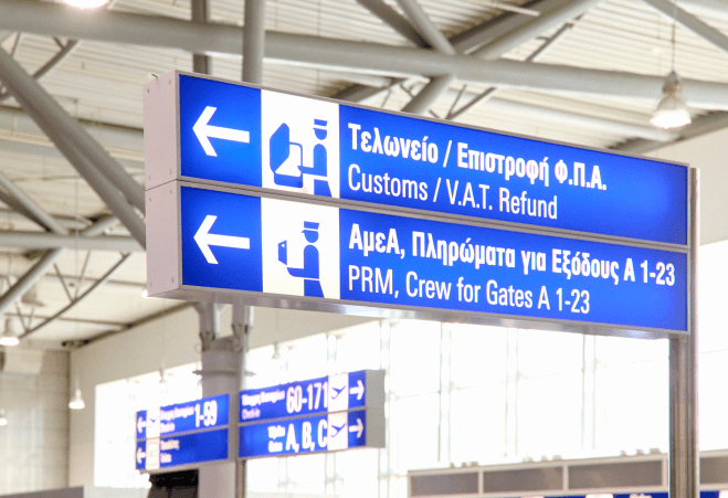 Signage showing customs and tax refund directions in Athens International Airport