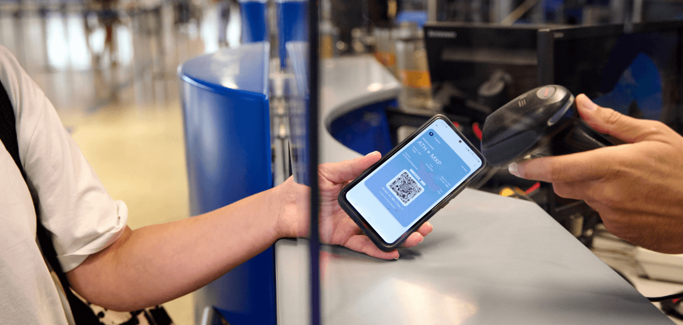 passenger showing mobile device to be scanned for checkin athens international airport