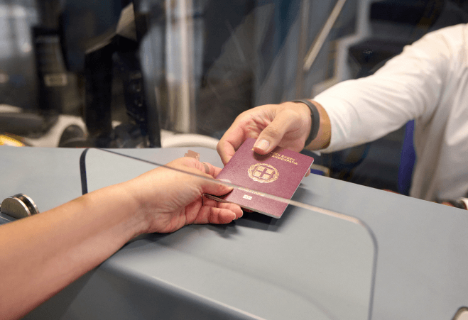 passenger delivering passport for check in athens international airport