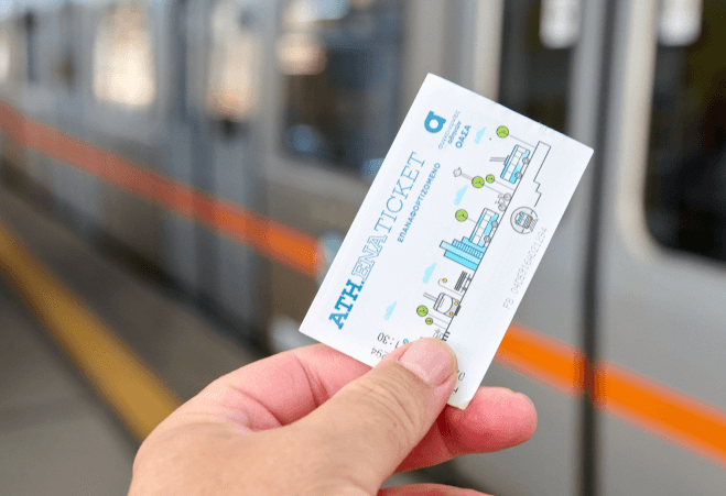 Passenger holding a transportation ticket at Athens International Airport